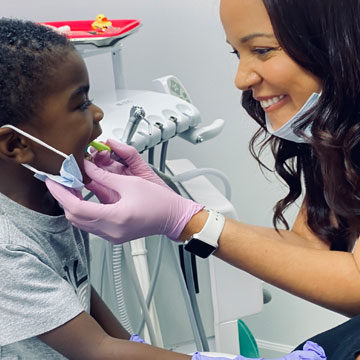 Dr. Tiffany A. Brady treating kids at LUV Pediatric Dentistry